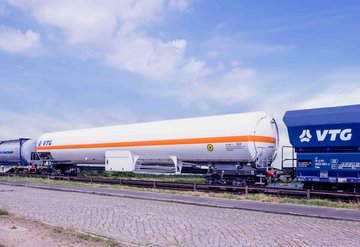 Attached white VTG tank car and blue standard freight car