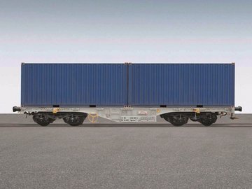 Grauer Containerwagen mit einem blauen Container darauf.